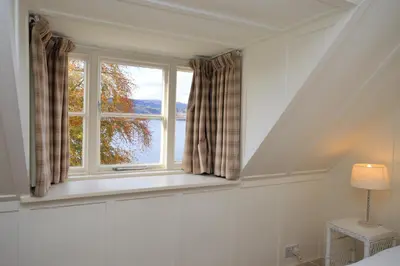 a bedroom with a window with a view at Darroch Beag in Saint Catherines