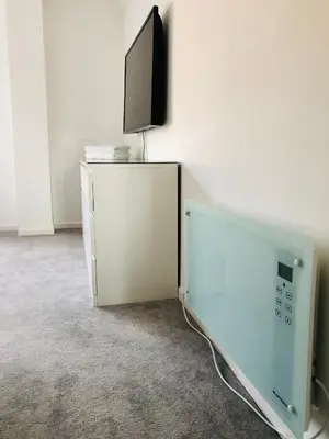 a tv sitting on top of a cabinet with a wii at Modern 2 bedroom Apartment Near City Centre in Glasgow