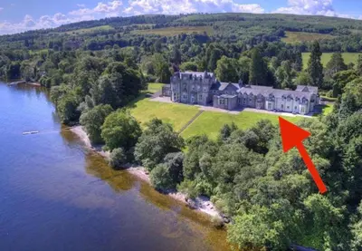 an aerial view of a large house with a red arrow at Loch View at Lomond Castle in Balloch