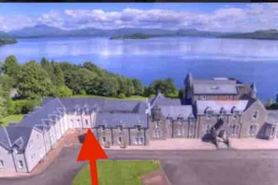 an aerial view of a building with a red arrow at Loch View at Lomond Castle in Balloch