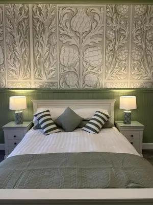 a bedroom with a large bed with two lamps at Royal Bank Flat in Oban