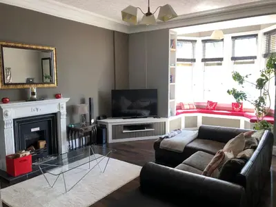 a living room with a couch and a fireplace at Royal Bank Flat in Oban
