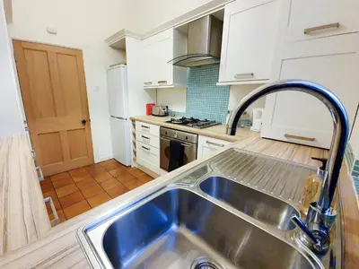 a kitchen with a stainless steel sink in a kitchen at Linburn House Apartment in Dunfermline