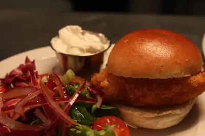 a chicken sandwich and salad on a plate with dip at Argyll Hotel in Bellochantuy