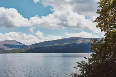 a view of a lake with mountains in the background at Brambles of Inveraray in Inveraray