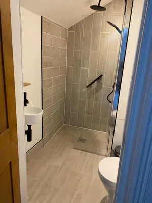 a bathroom with a shower and a toilet and a sink at The Colintraive in Colintraive