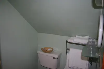 a bathroom with a toilet with a bowl on top of it at Royal Hotel in Girvan