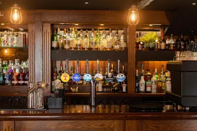 a bar with a lot of bottles of alcohol at The Smiddy Haugh in Auchterarder