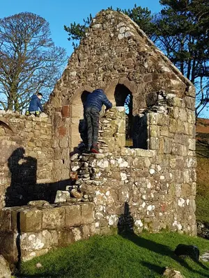 two men standing on top of a stone wall at St.Ebba B&B in Rothesay