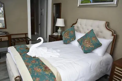 a bedroom with a bed with a swan on it at The Glenburn Hotel in Rothesay