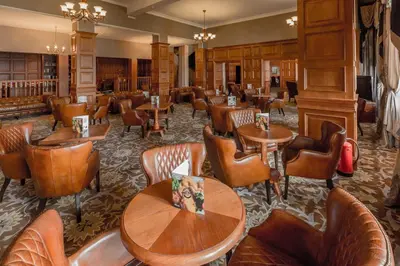 a restaurant with wooden tables and chairs at The Glenburn Hotel in Rothesay