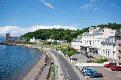 a view of a street in a town next to the water at The Great Western Hotel in Oban