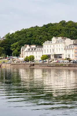 a group of buildings next to a body of water at The Great Western Hotel in Oban