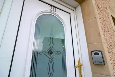 a glass door with a peace sign on it at Signature - Stanfield House in Motherwell