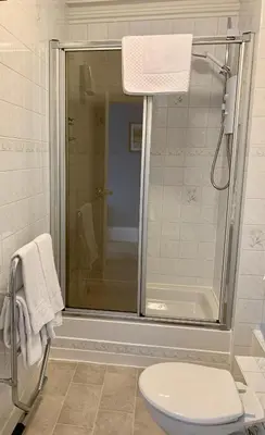 a bathroom with a shower and a toilet at Leven House Bed and Breakfast in Crieff