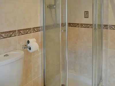 a shower with a glass door in a bathroom at West Tannacrieff in Stewarton