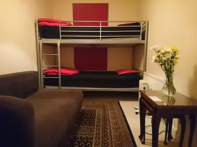 a living room with a couch and a bunk bed at Central and Convenient in Edinburgh