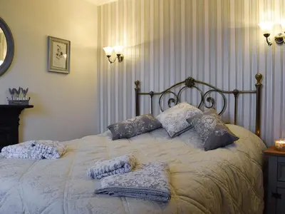 a bedroom with a bed with pillows on it at Ben Ledi View in Callander