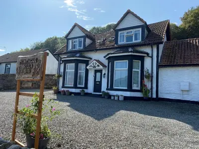 a house with a sign in front of it at Montague Villa in Dunoon