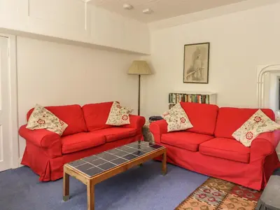 a living room with two red couches and a coffee table at Balmeanoch in Lochearnhead