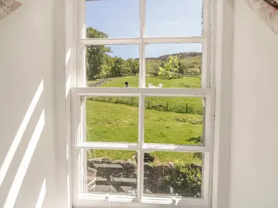 an open window with a view of a field at Balmeanoch in Lochearnhead