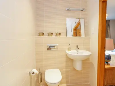 a bathroom with a toilet and a sink at Apartment 1 St Mary's Church in Moffat
