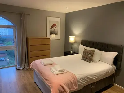 a bedroom with a bed with two towels on it at Stunning 2 Bed Merchant City Apartment with Residents Parking (Bell 2) in Glasgow
