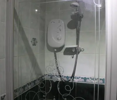 a shower in a bathroom with a camera on the wall at Loch Arklet House in Stirling