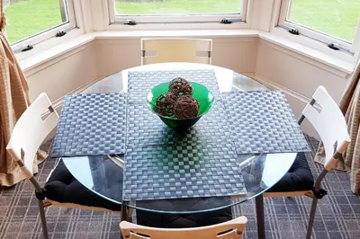 a glass table with a bowl of food on it at Glen View Apartments in Port Glasgow