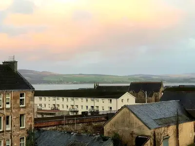 a city with buildings and a body of water at Glen View Apartments in Port Glasgow