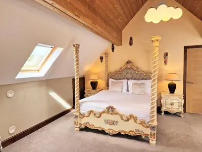 a bedroom with a canopy bed in a room at Lbtie Lodge with Two Private Hot Tubs - Fife - Loch Leven - Lomond Hills in Kelty