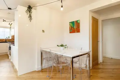 a kitchen with a table and chairs in a room at Central, Bright 2 Bed Flat - Pool & Sauna in Edinburgh