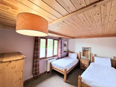 a bedroom with two beds and a window at Torridon 1 with Private Hot Tub - Fife - Loch Leven - Lomond Hills- Pet Friendly in Kelty