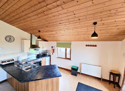 a kitchen with wooden ceilings and a counter top at Lomond 3 with Private Hot Tub - Fife - Loch Leven - Lomond Hills -Pet Friendly in Kelty