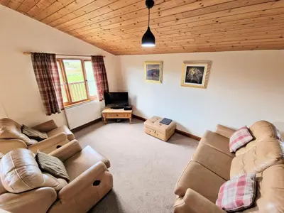 a living room with two couches and a tv at Lomond 3 with Private Hot Tub - Fife - Loch Leven - Lomond Hills -Pet Friendly in Kelty