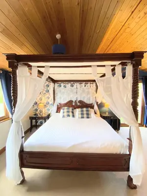 a bedroom with a large bed with a canopy at Lomond 5 with Private Hot Tub - Fife - Loch Leven - Lomond Hills - Pet Friendly in Kelty