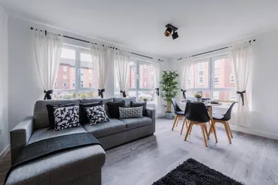 a living room with a couch and a table at RelaxingSleep Apartments in Glasgow