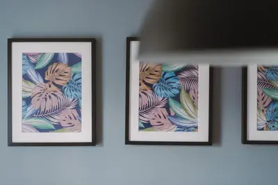 three framed pictures hanging on a wall at RelaxingSleep Apartments in Glasgow