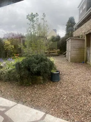 a backyard with a garden with a wooden shed at Garron House in Auchterarder