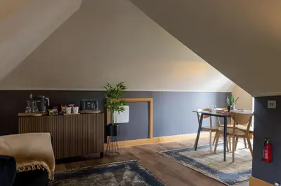 a living room with a table and a blue wall at Glenview Luss in Luss