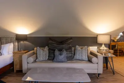 a living room with a couch with pillows at Glenview Luss in Luss