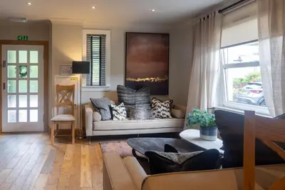 a living room with a couch and a window at Glenview Luss in Luss