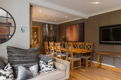 a living room with a couch and a dining room at Glenview Luss in Luss