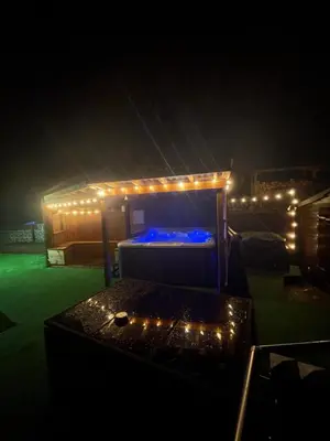 a room with a bed with lights on it at Amazing Alps and Loch views - HOT TUB and pet friendly in Arrochar