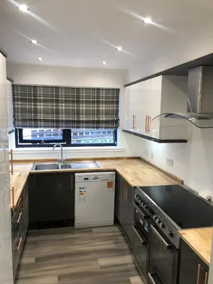 a kitchen with a sink and a stove top oven at Amazing Alps and Loch views - HOT TUB and pet friendly in Arrochar