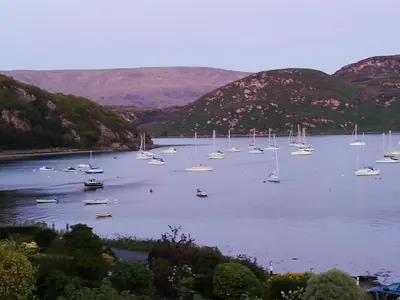 a bunch of boats in a large body of water at Upper Alta Apartment in Tighnabruaich
