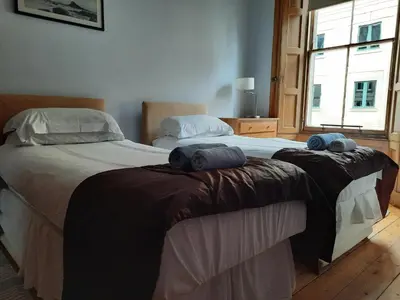 a bedroom with two beds with towels on them at Cornwall Street - 297 in Edinburgh
