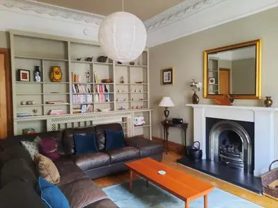 a living room with a couch and a fireplace at Cornwall Street - 297 in Edinburgh