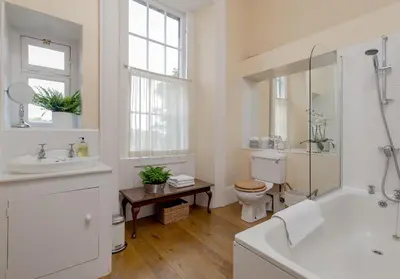 a white bathroom with a toilet and a sink at Saxe Coburg Place - 325 in Edinburgh