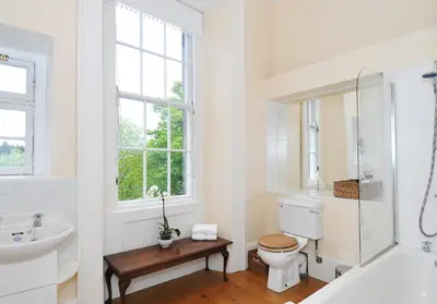 a white bathroom with a toilet and a sink at Saxe Coburg Place - 325 in Edinburgh